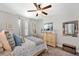 Bright bedroom featuring a comfortable bed, a dresser, and nautical decor at 8226 Summer Brook Ct, Land O Lakes, FL 34638