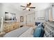 Cozy bedroom features a bed with blue accent pillows and a dresser with decor at 8226 Summer Brook Ct, Land O Lakes, FL 34638