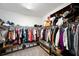 Walk in closet with shelving and organizers filled with clothing and shoes at 8226 Summer Brook Ct, Land O Lakes, FL 34638