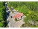 A high aerial view of the gate house featuring a red roof surrounded by well manicured landscaping at 8226 Summer Brook Ct, Land O Lakes, FL 34638