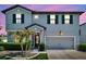 Charming two-story home boasts a gray exterior, manicured landscaping, and an attached two-car garage at 8226 Summer Brook Ct, Land O Lakes, FL 34638