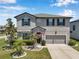 Two-story home with a well-maintained lawn, manicured landscaping, and an attached garage at 8226 Summer Brook Ct, Land O Lakes, FL 34638