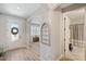 Bright foyer with decorative window, wood-look flooring, and views of the living room and bathroom at 8226 Summer Brook Ct, Land O Lakes, FL 34638