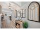 Inviting hallway features decorative wall mirrors, wood-look flooring, and a view into the dining area at 8226 Summer Brook Ct, Land O Lakes, FL 34638