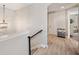 Bright upstairs hallway with wood floors, a decorative light fixture, and easy access to bedrooms at 8226 Summer Brook Ct, Land O Lakes, FL 34638