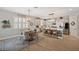 Open kitchen and dining area with light wood floors, an island with stools and modern appliances at 8226 Summer Brook Ct, Land O Lakes, FL 34638