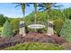 A decorative stone sign and manicured landscaping welcomes you to Lake Shore Ranch at 8226 Summer Brook Ct, Land O Lakes, FL 34638