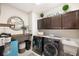 Well-organized laundry room with modern appliances, storage cabinets, and shelving at 8226 Summer Brook Ct, Land O Lakes, FL 34638