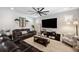 Well-lit living room featuring wood-look floors, a ceiling fan, and stylish decor at 8226 Summer Brook Ct, Land O Lakes, FL 34638