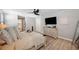 Spacious main bedroom with wood floors, a ceiling fan, and a doorway leading to a luxurious bathroom at 8226 Summer Brook Ct, Land O Lakes, FL 34638