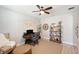 Bright home office with wooden desk, comfortable chair, decorative shelving, and a ceiling fan at 8226 Summer Brook Ct, Land O Lakes, FL 34638