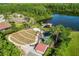 Aerial view of a neighborhood park featuring walking paths and a shaded playground near a lake at 8226 Summer Brook Ct, Land O Lakes, FL 34638