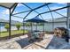 Relaxing outdoor patio with umbrella-covered table, chairs, and playhouse in the backyard at 8226 Summer Brook Ct, Land O Lakes, FL 34638