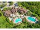 Aerial view of community clubhouse and pool area with ample seating and lush landscaping at 8226 Summer Brook Ct, Land O Lakes, FL 34638