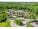 Aerial view of a community pool and clubhouse surrounded by lush landscaping at 8226 Summer Brook Ct, Land O Lakes, FL 34638