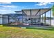 Spacious screened patio with comfortable seating and an entertainment area at 8226 Summer Brook Ct, Land O Lakes, FL 34638