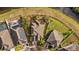An aerial view of the home showcases a lush yard, patio and neighboring houses at 8429 Hunters Fork Loop, Ruskin, FL 33573