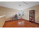 Bright bedroom featuring hardwood floors, a desk, and a bookshelf filled with books at 8429 Hunters Fork Loop, Ruskin, FL 33573