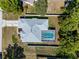 Inviting property with a screened pool, surrounded by a privacy fence and a beautifully landscaped yard at 8604 Vicksburg Rd, Spring Hill, FL 34608