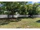 Spacious backyard features a well-maintained lawn, mature trees, and a full privacy fence at 8604 Vicksburg Rd, Spring Hill, FL 34608