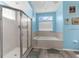 Bright bathroom features tiled shower and tub; the perfect space for relaxation at 8604 Vicksburg Rd, Spring Hill, FL 34608