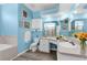 Bathroom offering double sinks, vanity, commode, and shower with bright lighting and calming blue walls at 8604 Vicksburg Rd, Spring Hill, FL 34608