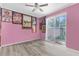 Spacious bedroom features large sliding doors and a ceiling fan for ultimate comfort and style at 8604 Vicksburg Rd, Spring Hill, FL 34608
