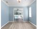 Light-filled bedroom with wood-look floors, sliding glass door, and neutral paint at 8604 Vicksburg Rd, Spring Hill, FL 34608