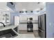Charming kitchen with stainless steel appliances, light countertops, and adjacent pool view at 8604 Vicksburg Rd, Spring Hill, FL 34608