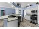 Bright kitchen features stainless steel appliances, light countertops and open to a pool view at 8604 Vicksburg Rd, Spring Hill, FL 34608