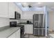 Well-lit kitchen features stainless steel appliances, white cabinets, and a sleek design at 8604 Vicksburg Rd, Spring Hill, FL 34608