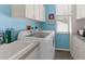 Well-equipped laundry room with modern machines and ample storage at 8604 Vicksburg Rd, Spring Hill, FL 34608
