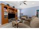 Open living room with wood-look floors, built-in shelving, and comfortable seating at 8604 Vicksburg Rd, Spring Hill, FL 34608