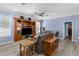 Open living room with wood-look floors, built-in shelving, and comfortable seating at 8604 Vicksburg Rd, Spring Hill, FL 34608