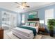 Serene main bedroom with ceiling fan, en-suite bath and sliding glass door to the backyard at 8604 Vicksburg Rd, Spring Hill, FL 34608