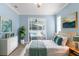 Inviting main bedroom with sliding glass doors to the backyard, ceiling fan and en-suite bath at 8604 Vicksburg Rd, Spring Hill, FL 34608