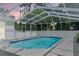 Refreshing screened-in pool with ample space for relaxation and recreation under a clear sky at 8604 Vicksburg Rd, Spring Hill, FL 34608