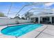 Inviting screened-in pool area, ideal for relaxation and entertaining in a private backyard oasis at 8604 Vicksburg Rd, Spring Hill, FL 34608