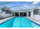 Sparkling in-ground pool enclosed by a screened lanai, perfect for year-round outdoor enjoyment at 8604 Vicksburg Rd, Spring Hill, FL 34608
