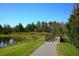 Paved walking path passes a scenic bridge over the pond with lush landscaping perfect for enjoying neighborhood's scenery at 9368 Gladsome Dr, Land O Lakes, FL 34637
