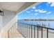 Balcony with aluminum railings overlooking the water and a view of the beautiful blue sky at 9901 1St E St # D, Treasure Island, FL 33706