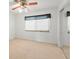 Bedroom featuring a window, carpet flooring, ceiling fan, and built-in closet, creating a cozy retreat at 9901 1St E St # D, Treasure Island, FL 33706