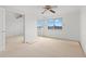 Well-lit bedroom featuring a large window and mirrored closet at 9901 1St E St # D, Treasure Island, FL 33706