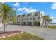 Modern condo complex with landscaped front and brick paved entrance at 9901 1St E St # D, Treasure Island, FL 33706