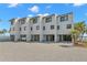 Modern townhome exterior with private garages, sleek design, and meticulously landscaped grounds at 9901 1St E St # D, Treasure Island, FL 33706