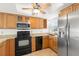 Well-equipped kitchen featuring stainless steel appliances, granite countertops and wood cabinets at 9901 1St E St # D, Treasure Island, FL 33706