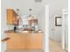 Open kitchen featuring stainless steel appliances, wood cabinets, and a breakfast bar at 9901 1St E St # D, Treasure Island, FL 33706