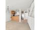 Open-concept living room with adjacent kitchen and staircase, offering a comfortable and inviting space at 9901 1St E St # D, Treasure Island, FL 33706