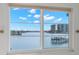 Scenic water view from a bright window, showcasing boats and waterfront buildings at 9901 1St E St # D, Treasure Island, FL 33706