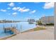 Stunning waterfront view showcases a private dock, serene water, and picturesque buildings along the horizon at 9901 1St E St # D, Treasure Island, FL 33706